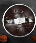 Compact Automatic Freshly Ground Coffee Brewer With Onboard Bean Grinder And Programmed Cup Settings top view of coffee grinder with ground coffee and beans.