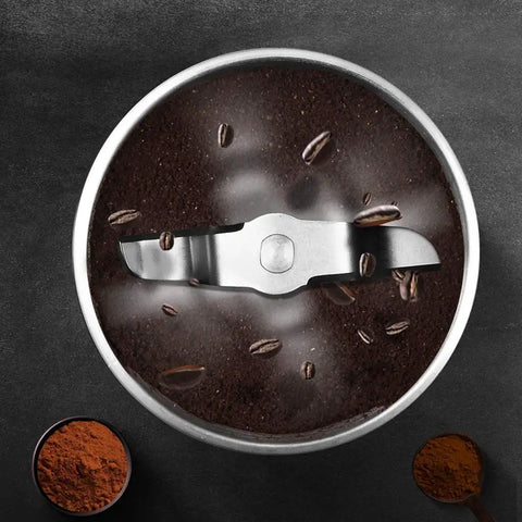 Compact Automatic Freshly Ground Coffee Brewer With Onboard Bean Grinder And Programmed Cup Settings top view of coffee grinder with ground coffee and beans.