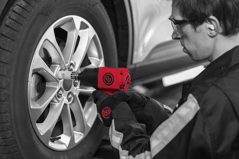 Mechanic using CP7741 Half Inch Air Impact Wrench With Twin Hammer Power For Auto Repair And Shop to tighten wheel bolts.