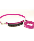 Bale Band For Hay Hauling Made Easy With Durable Webbing And Heavy Duty Cam Buckle Snaps On Smoothly Tightens Quickly And Lets You Lift Neatly Tied Hay With An Ergonomic Rubber Handle Raspberry Band shown with black ergonomic handle.