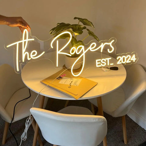 Custom Neon Sign Lit Up Name Sign LED Light for wall decor on round table with 13ft power cord, glowing text The Rogers Est. 2024