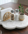 Genuine White Capiz Shell Rotating Lazy Susan Serving Tray For Dining Tables Features scalloped design with salt, pepper, napkin holder, and plant.