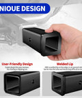 Hand holding 2.5 Inch Class V To 2 Inch Trailer Hitch Reducer Sleeve with focus on unique user-friendly design