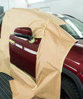 Red car door covered with paper using eight roll masking tape and paper set with six paper rolls and two yellow painter tapes