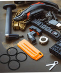 4 Piece Thick Automotive Rubber Rings Quick Release Bumper Fasteners Kit shown with various automotive tools and parts