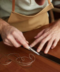 Person using Leather Craft Tool Set Six Piece With Four Edge Bevelers In 0.8mm, 1.0mm, 1.2mm, 1.5mm, Plus Cutting Knife on leather strip.