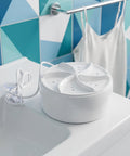 Compact Portable Mini Washing Machine Turbine Laundry Cleaner For Socks Undies And Delicates on a sink with a white background.