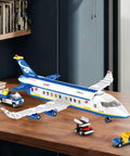 6 In 1 Airport Passenger Plane Building Set With 510 Pieces for STEM on table showing plane, baggage truck, and shuttle bus.