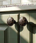 Oil Rubbed Bronze Round Cabinet Knobs 12 Pack 1.4 Inch Diameter Zinc Alloy Hardware on green cabinets