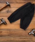 Heavy Duty Waterproof PU Arm Sleeves Extended Length Oversleeve Protectors Tough As Nails For Grease And Grime No Sweat Reusable Oil Water Resistant Gear For Messy Kitchen Cooking And Garage Work Pack Of Two Black on wooden surface with hammers.