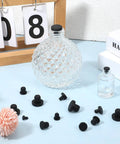 80 Piece Silicone Rubber Hole Plugs Set For Round Holes 4mm To 9.5mm Waterproof Stoppers displayed with glass bottles