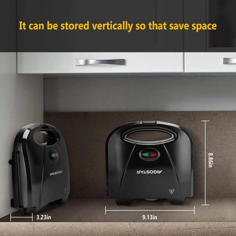Aigostar Flat Sandwich Maker With Nonstick Deep Grill Surface, Black stored vertically in a kitchen cabinet for space-saving.