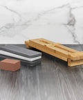 Zwilling 3000 Grit Glass Water Sharpening Stone displayed with holder on grey surface