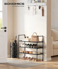 Three-Tier Shoe Rack Organizer For Hallways And Closets, Slim Space-Saving Metal Frame With Durable Non-Woven Fabric Shelves, Black Finish, Holds Up To 12 Pairs Of Shoes, Easy Assembly displayed in a hallway with shoes.