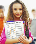 Girl holding 10 Pack Dry Erase Multiplication Boards 9 By 12 Inch Double Sided Whiteboards Classroom Ready For Times Tables Math Practice Kid Friendly With Erasers Included.