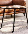 Top Tier Heavy Duty Table Leg Extenders With Casters Four Pack Adjustable Height Risers on a stylish coffee table.