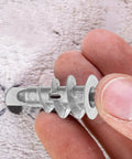 Close-up of Heavy Duty Drywall Anchors And Screws Kit self-drilling hollow wall anchor in zinc alloy held by fingers.
