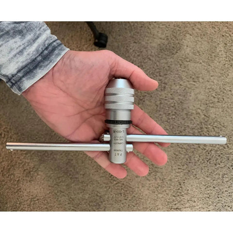 Hand holding Adjustable Ratcheting T Handle Tap Wrench With Dual Handles For Fast Accurate Thread Tapping M6 To M14 One Quarter Inch To One Half Inch Capacity Left And Right Hand Action Tool Set From Eastwood