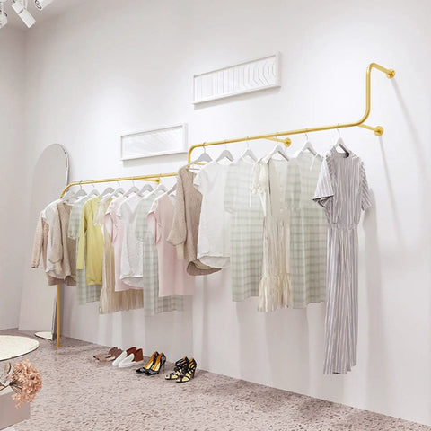 Sturdy Gold Iron Wall Mounted Clothing Rack 300cm for garments and shoes, heavy duty metal display bar in a minimalist room.