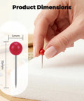 Close-up of a hand using a red Straight Up Go To Multi Color Map Push Pin on a foam surface, showcasing product dimensions.