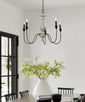 Magnolia Five Light Chandelier in white washed wood and matte black metal with exposed bulbs over dining table, modern rustic vibe