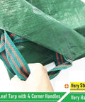 Individual holding green 7x7 Foot Waterproof Leaf Tarp with Four Handles for Yard Cleanup and Outdoor Projects