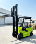 High Capacity Electric Side Loading Forklift For Seamless Warehouse Storage And Tough Construction Sites Built To Smash Heavy Cargo Without Breaking A Sweat, green forklift in open warehouse.