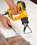 Using Heat Gun With LCD Display And Accessory Kit For DIY Projects, Adjustable Temperature In 50 Degree Increments on a wooden door