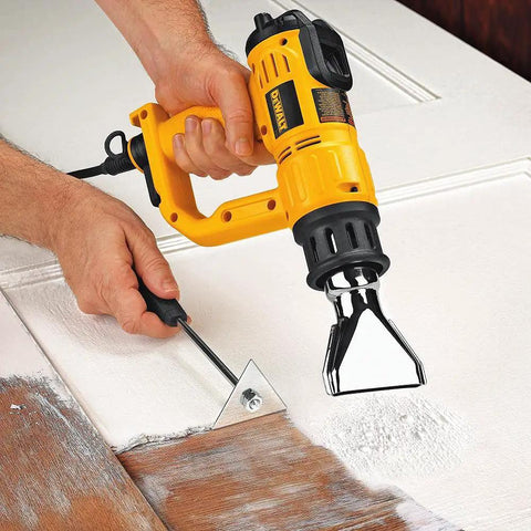 Using Heat Gun With LCD Display And Accessory Kit For DIY Projects, Adjustable Temperature In 50 Degree Increments on a wooden door