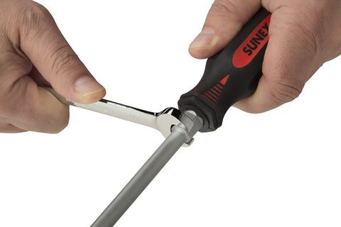 12 Piece Combination Screwdriver Set With Grippy Overmolded Handles Vapor Blasted Tips For Durability Matte Finish To Resist Flakes Quick Reference On Handle End And Bolster For Extra Torque On Slotted And Phillips Drivers being used with a wrench for extra torque