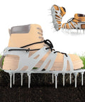 Lawn Aerator Shoes with wrap-around lacing and spiked soles on tan boot, showing flexible and bendable sole on grass surface.