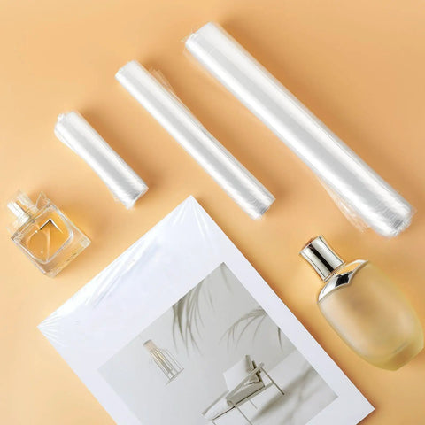 Premium Heat Shrink Bags With Self Adhesive Edge And Crystal Clear Film For Effortless Diy Crafting Gift Wrapping Includes 4x6 7x10 Plus 10x14 Packs displaying rolls and packaged items.