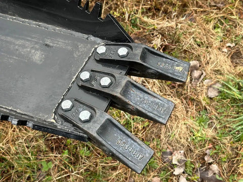 Close-up of replaceable teeth on Mega Wrecker stump bucket for tractors and skid steers up to 105 HP with bi-directional ripping edge.