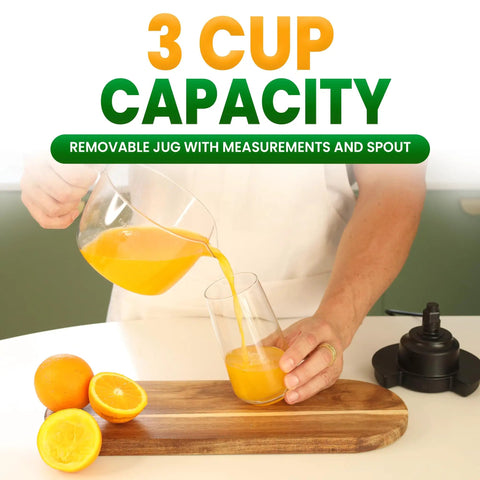 Primtronic Electric Citrus Juicer With Large 24 Oz Capacity And Seed Filter Auto Reverse Function Compact Design For Oranges Lemons Limes BPA Free Black Orange pouring fresh orange juice from a 3-cup capacity pitcher into a glass.