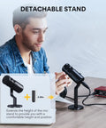 Man using XLR Dynamic Podcast Microphone With Cardioid Pickup, Built In Double Layer Pop Filter, on desk with detachable stand.