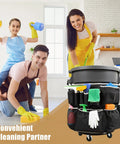 Upgraded Large Trash Can Caddy Bag With Multi Pocket Organizer For 32 To 55 Gallon Bins Turns Your Garbage Bin Into A Mobile Cleaning Station Ideal For House Cleaners And Janitorial Duties Gray Edge, shown attached to a bin with various cleaning supplies in use by smiling family.