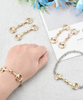 Six Piece Set Medium Horse Bit Buckles D Ring Gold Snaffle Buckles on bracelet and loose on table