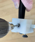 Close-up of Pro Grade Window Screen Pin Plunger Jig Tool in use, drilling a hole into a screen frame for DIY repairs.