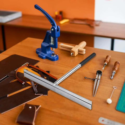 15.25 Inch Sheet Metal Folding Hemming Tool with Heavy Duty Steel Construction on workshop table surrounded by leather tools