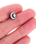Close-up of Ten Piece Laptop Hard Drive Screws Kit M3 miniature black screw held in hand, for HDD repair and PC hardware maintenance.