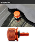 Knurled Aluminum Rear Seat Screw With Rubber Ring For Quarter Inch Twenty Thread Fits Touring Sportster Softail Dyna Street Glide Road King Fat Bob 1996 2025 Orange, showing front view and installed on Harley seat