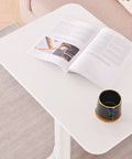 Rock Solid Adjustable Lectern Podium Stand With Expansive Desktop Board Built Tough For Daily Grind Provides Smooth Height Adjustments with open magazine and coffee cup.