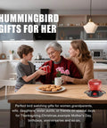Family exchanging gifts in kitchen with Hummingbird Feeder With Ant Moat For Outdoors 10 Oz Nectar Dispenser on table.