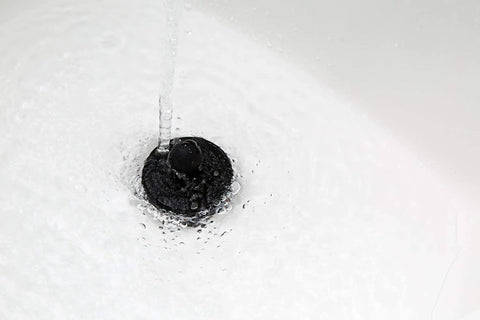 Universal Drain Stopper For Bathtub And Sink Your Go To Two Pack Black Plug in action sealing water in a sink