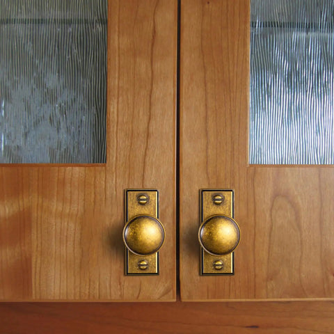 Six Pack Dope Antique Brass Cabinet Knobs With Backplates on wooden cupboard doors