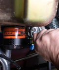 Person using Adjustable Oil Filter Wrench For Spin On Filters Two And Three Quarters To Three And One Quarter Inches on car filter