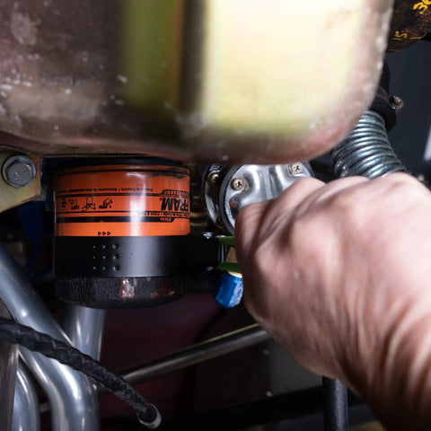 Person using Adjustable Oil Filter Wrench For Spin On Filters Two And Three Quarters To Three And One Quarter Inches on car filter