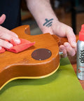 Premium Guitar Polish That Brings Your Axe Back To Life With A Blazing Clean Glossy Finish Includes Soft Microfiber Cloth application on guitar.