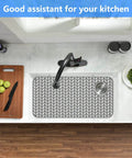 Top view of Pro Grade Silicone Sink Mat Grid for Kitchen Sink Protection in stainless steel sink with wooden countertop.
