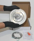 5.5 Inch Led Recessed Ceiling Light Trim Kit With Snap On Polycarbonate Lens And Trim Ring White Finish, held with gloves.